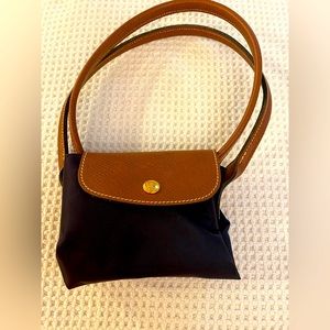 One small Longchamp foldable tote bag, eggplant/purple color, mint condition.